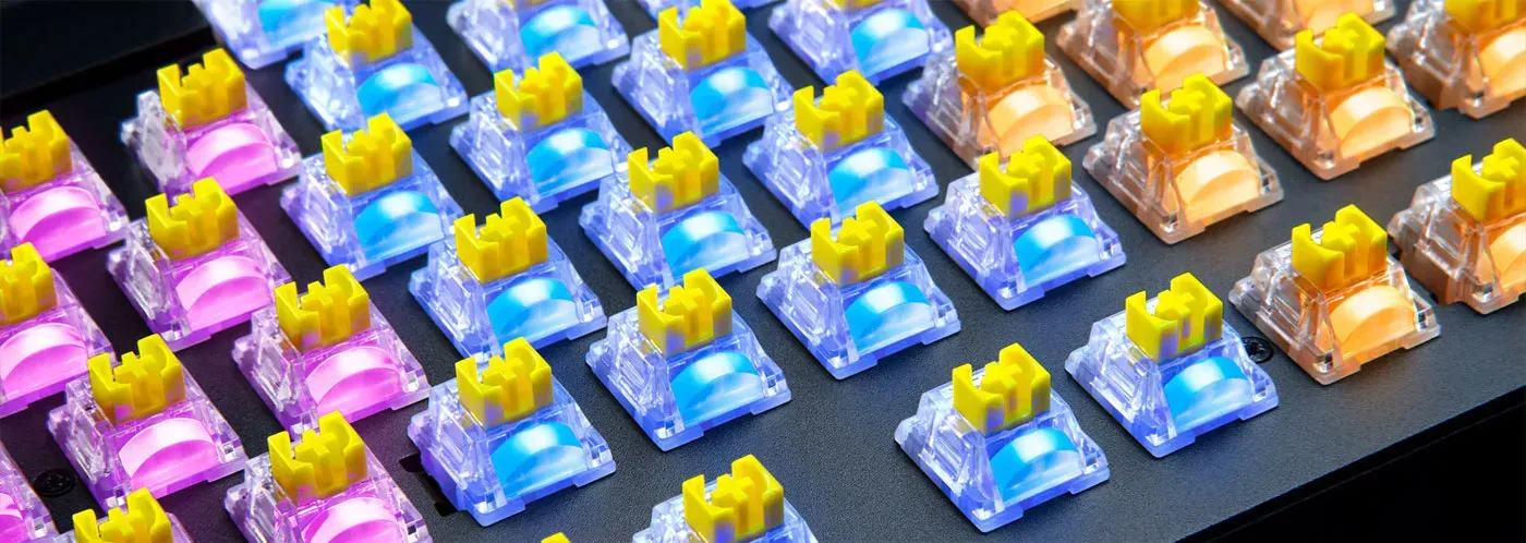 Transparent switch housing with LED lens for brighter RGB keyboard illumination