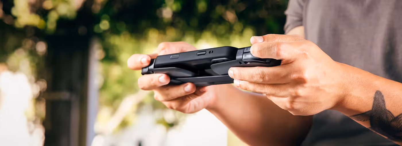 Mobile gaming controller attached to a smartphone while wearing a protective case