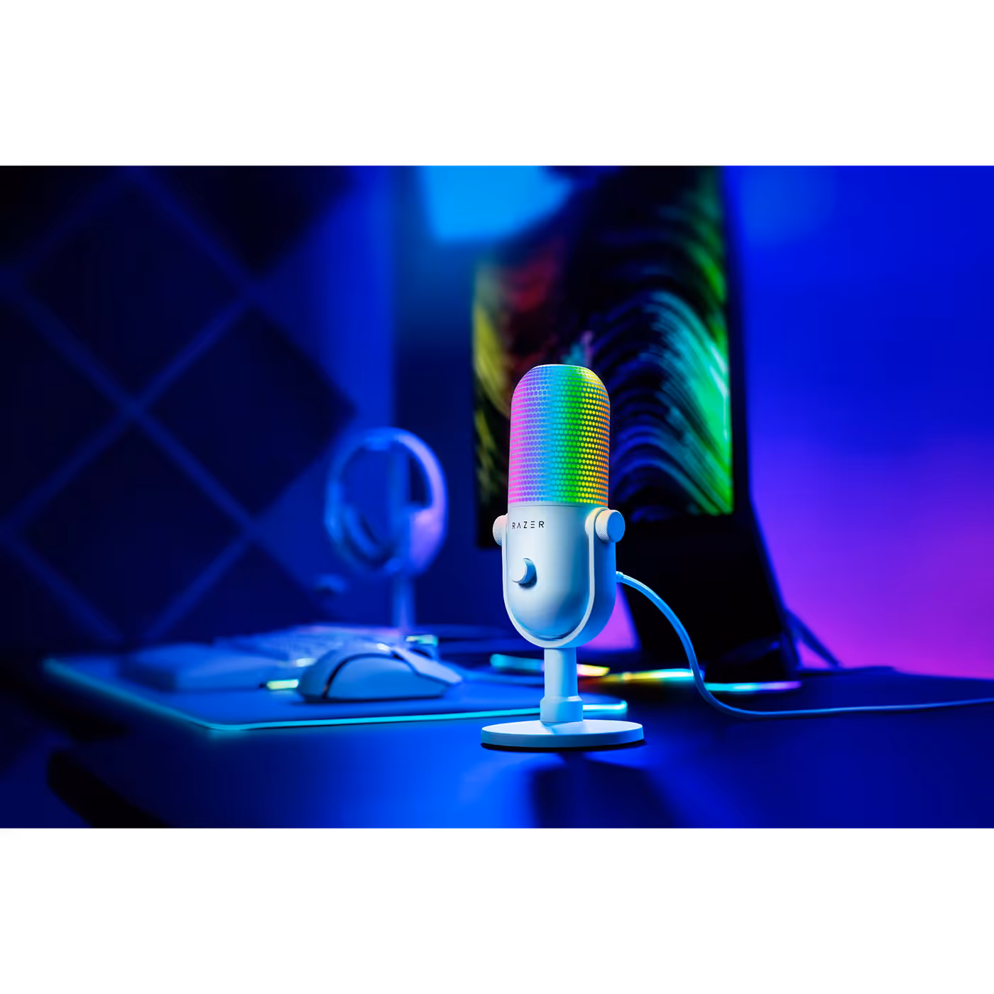White Razer Seiren V3 Chroma lit up on a desk setup