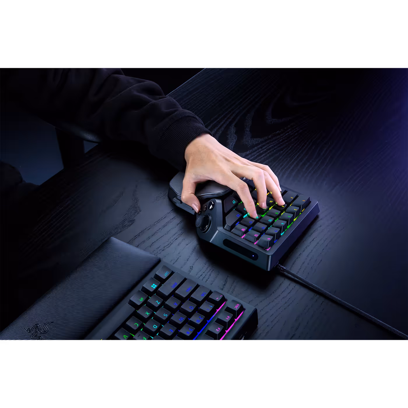 Hand on the Razer Tartarus V2 Pro next to a gaming keyboard