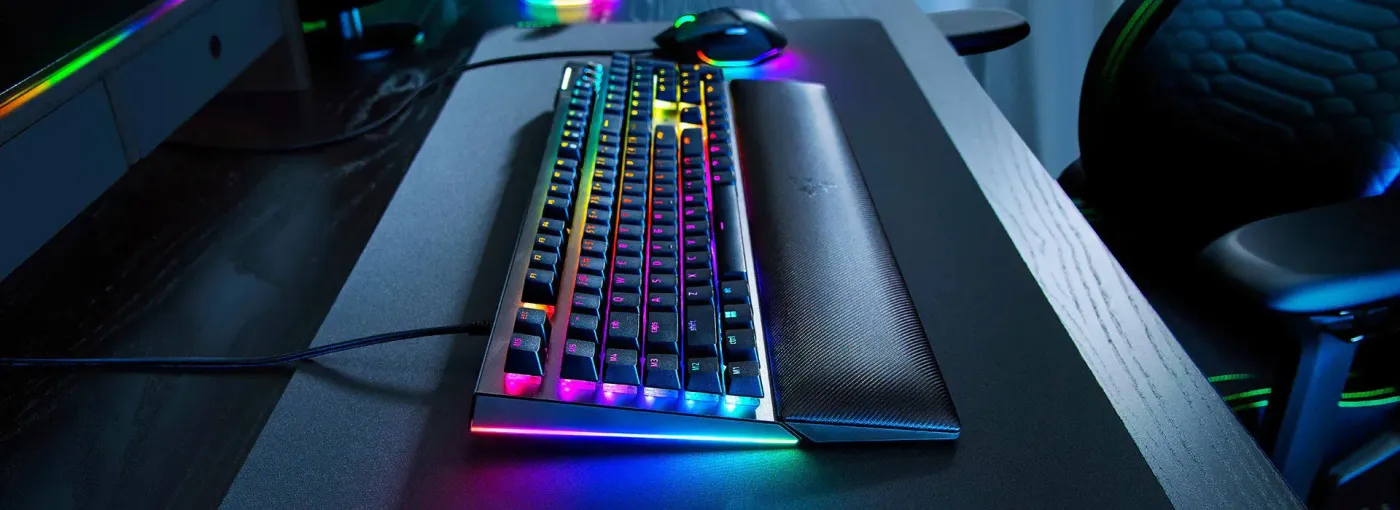 Close-up of Razer BlackWidow V4 showing per-key RGB lighting and atmospheric underglow