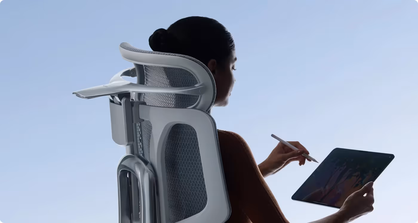 Person sitting upright in ergonomic chair