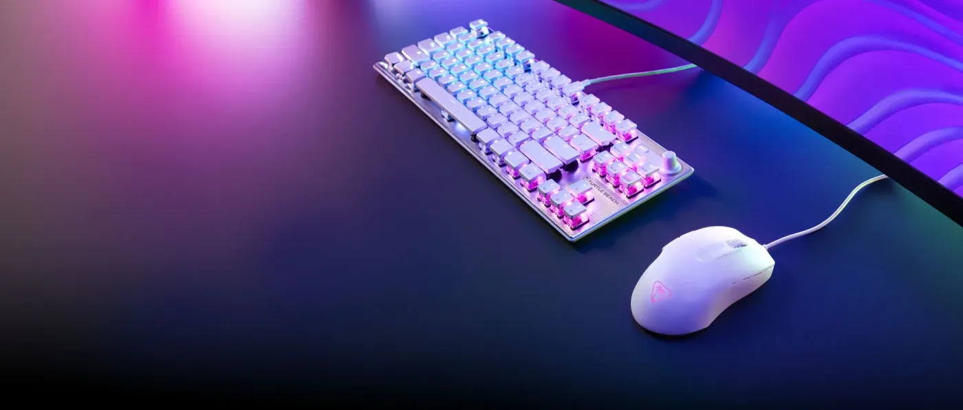 White Turtle Beach Pure SEL ultra-lightweight gaming mouse on a dark desk