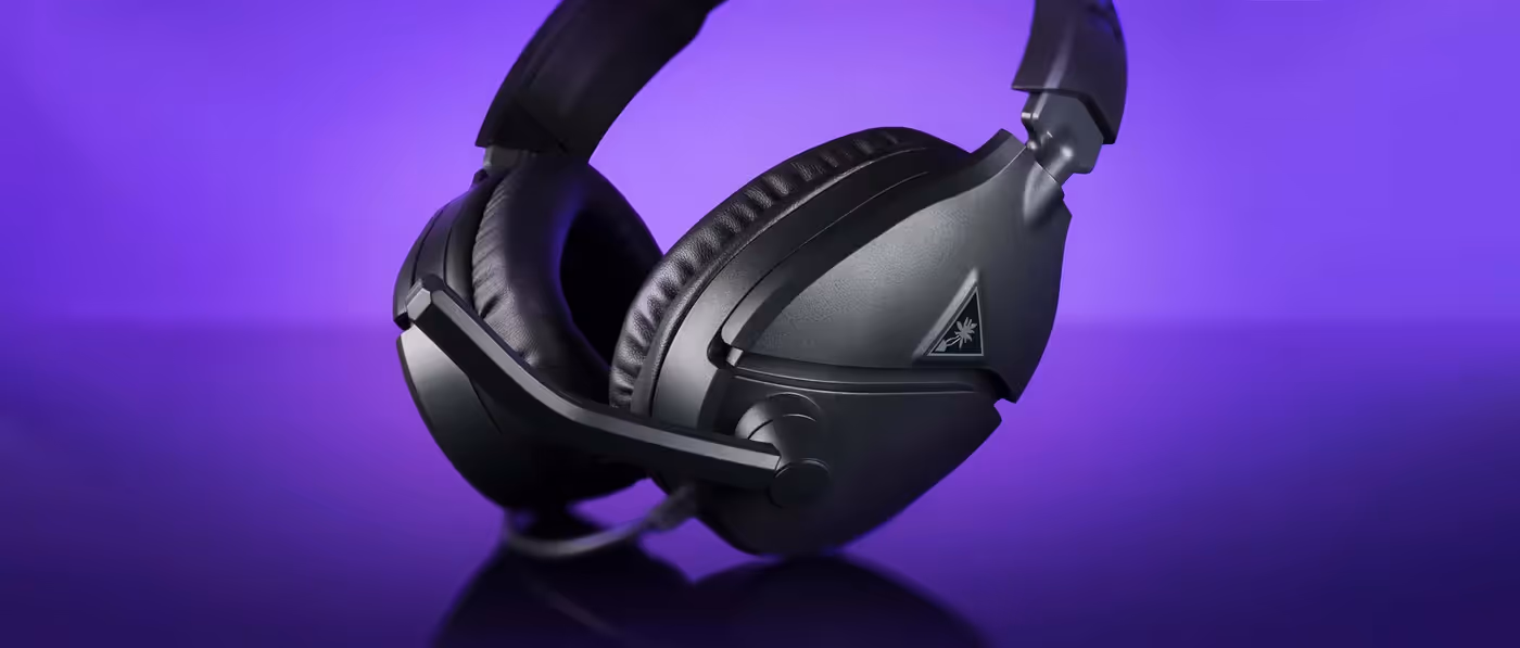 Sleek black Recon 70 gaming headset with plush ear cushions on purple background