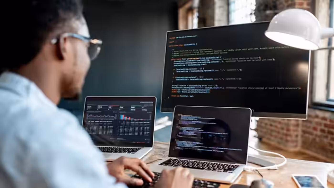 Software developer working on complex models on a computer screen