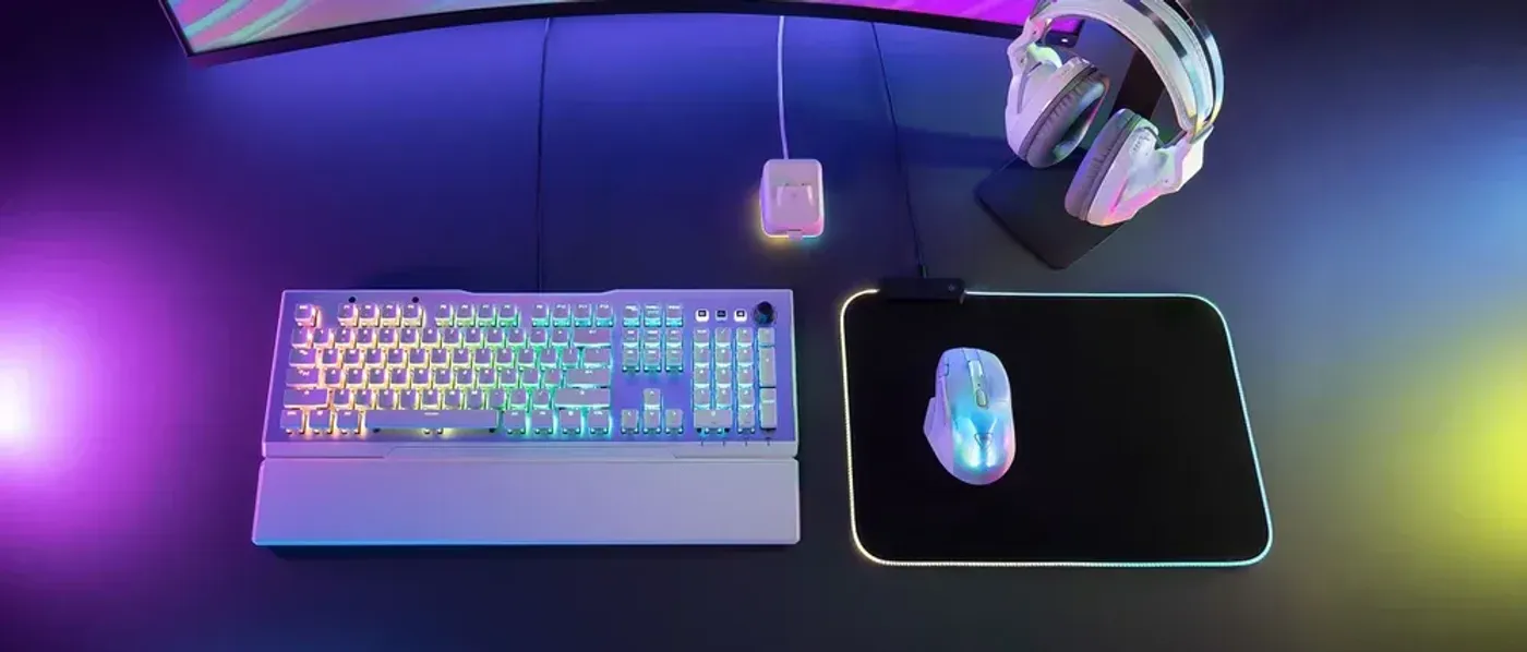 Gaming setup showcasing the translucent RGB AIMO lighting on the Kone XP Air