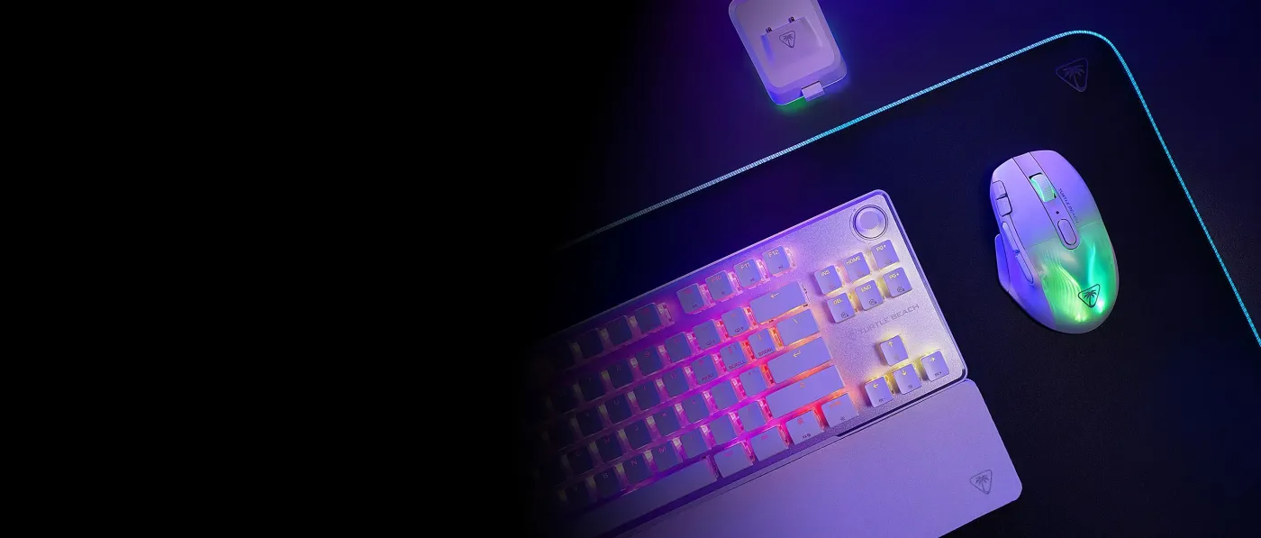 A gaming keyboard and mouse with RGB lighting on a black mouse pad, featuring a sleek design and a charging dock.