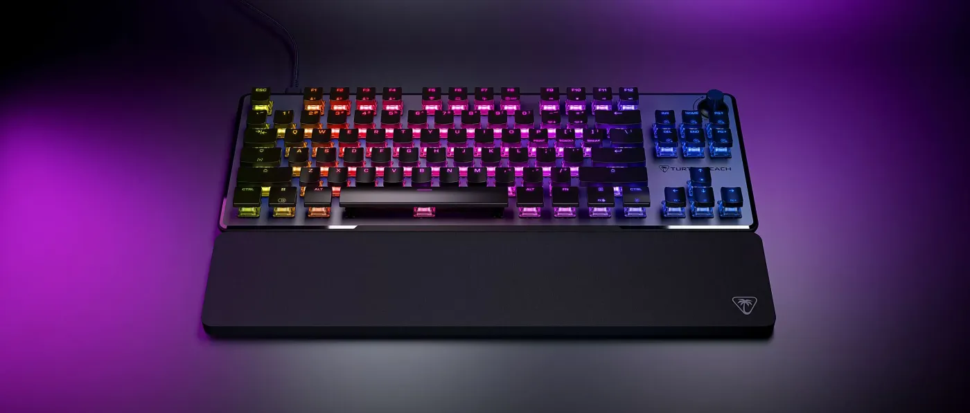 A gaming keyboard with colorful backlit keys and a sleek design, featuring a wrist rest and vibrant lighting effects.
