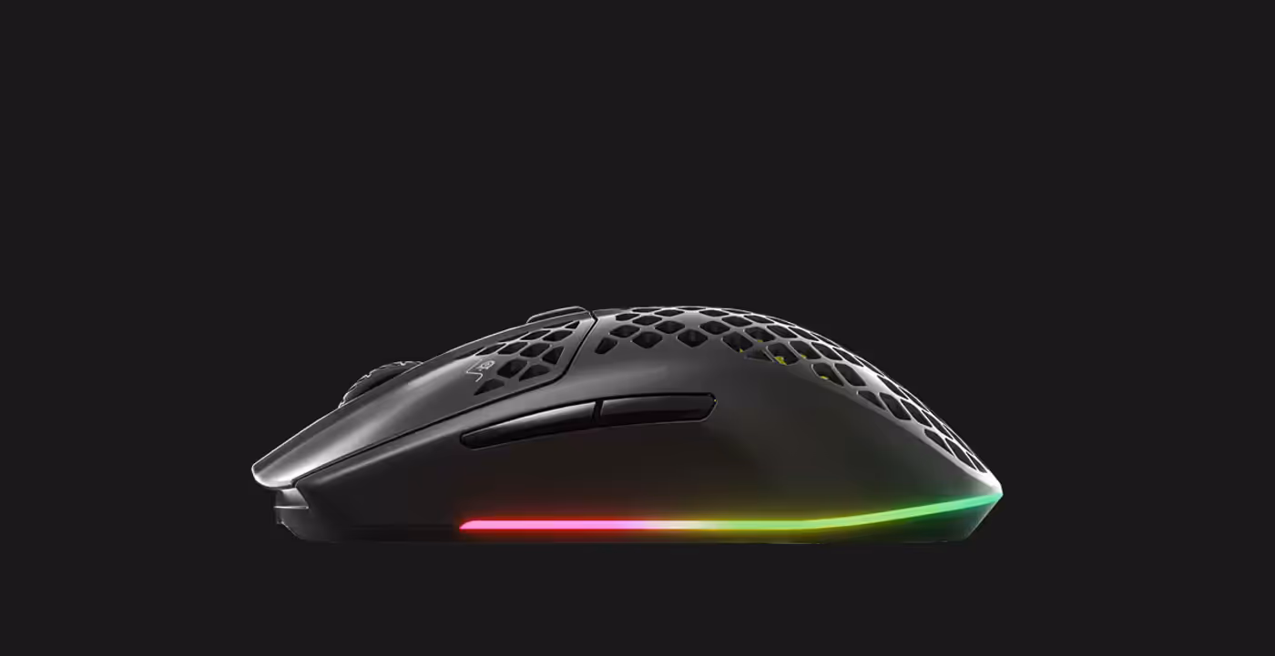 Aerox 3 Wireless mouse alongside its wireless receiver on a desk