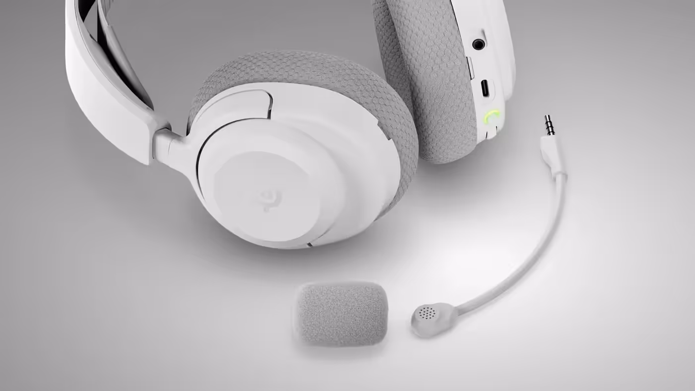 The white SteelSeries Arctis Nova 3P headset photographed on a desk setup
