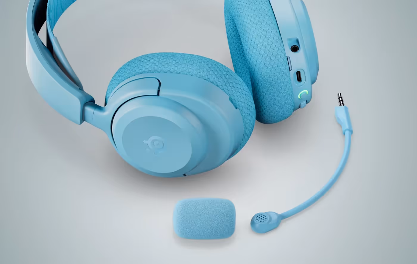 The aqua SteelSeries Arctis Nova 3X headset photographed on a desk
