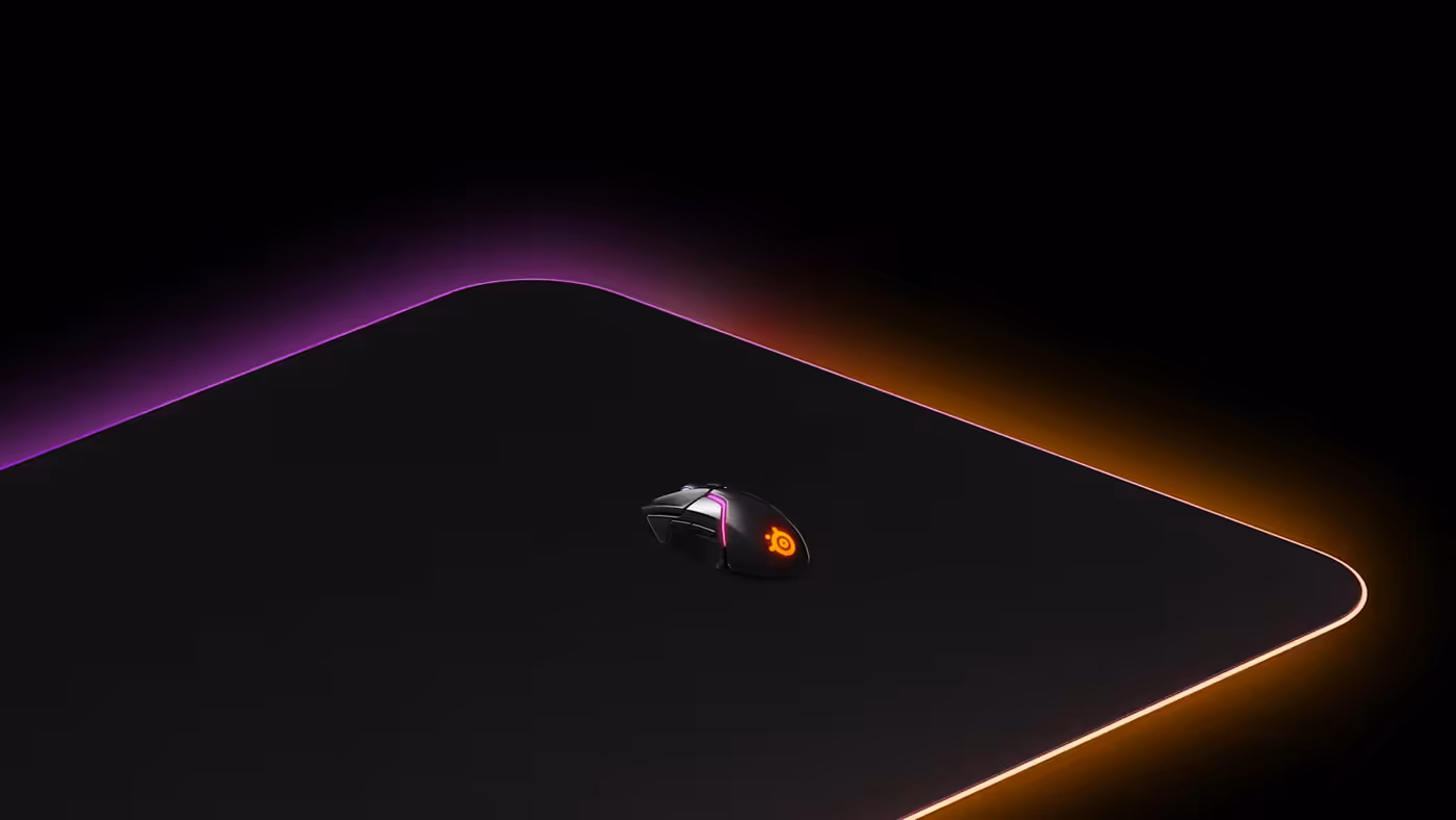 Illuminated QCK Prism mouse pad with a mouse on it, also in RGB colors