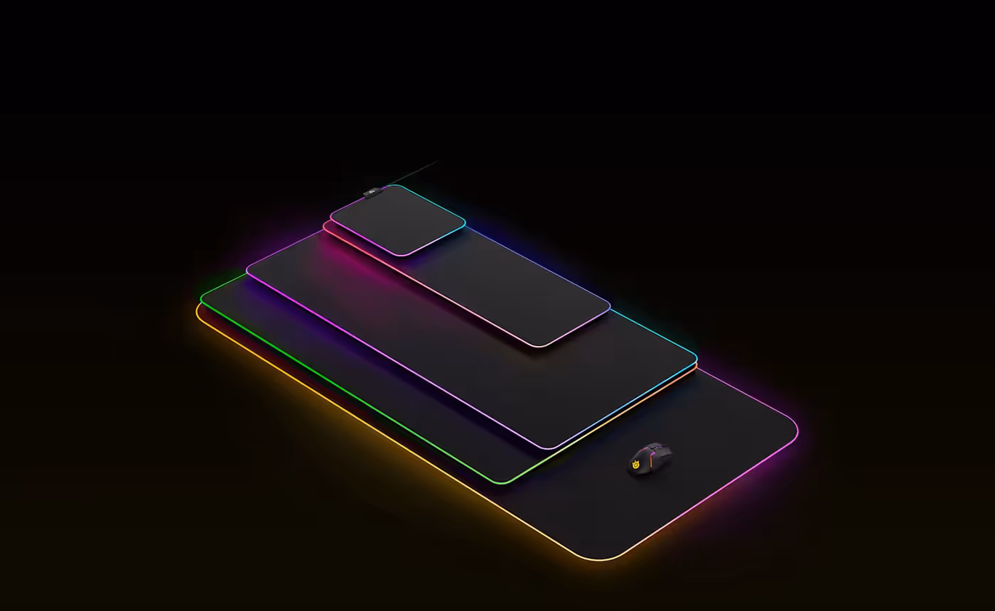 All the colorful SteelSeries Prism mousepads stacked on top of each other, illuminated in RGB colors.