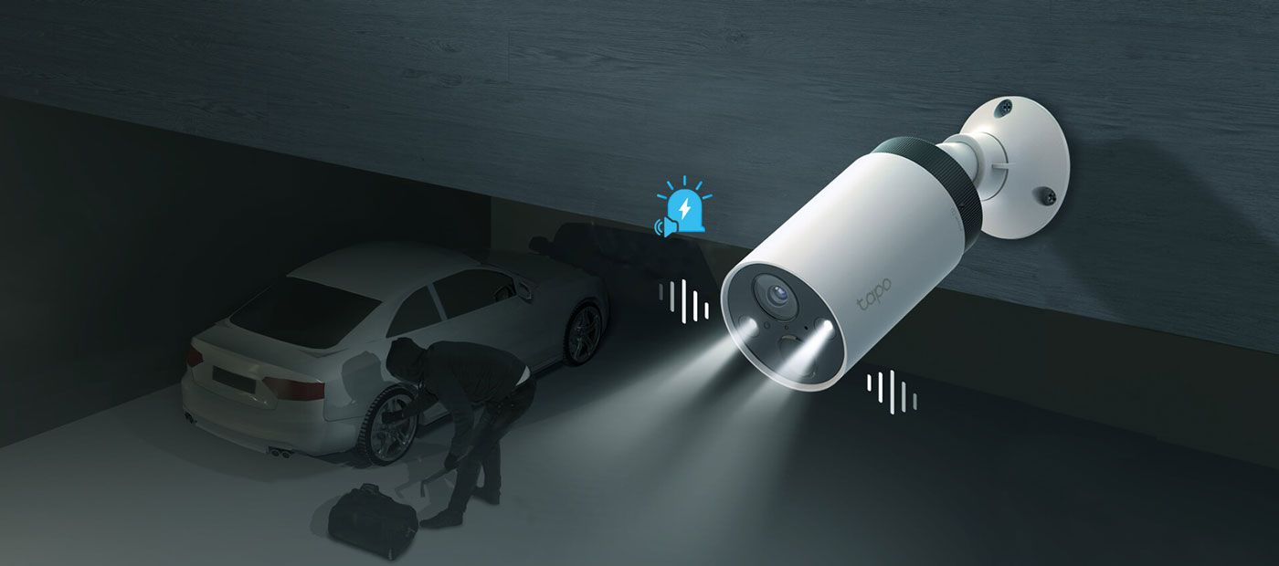 Tapo security camera sounding its alarm with the deterrent light flashing at night