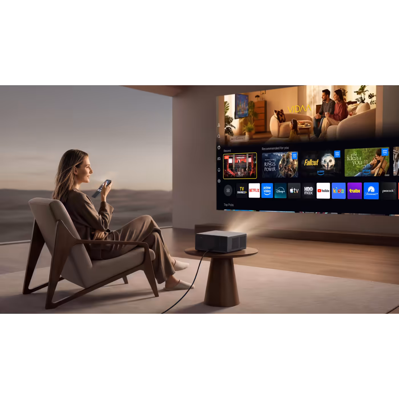 Woman with a remote in front of the VIDAA home screen projected by the Wanbo X5S