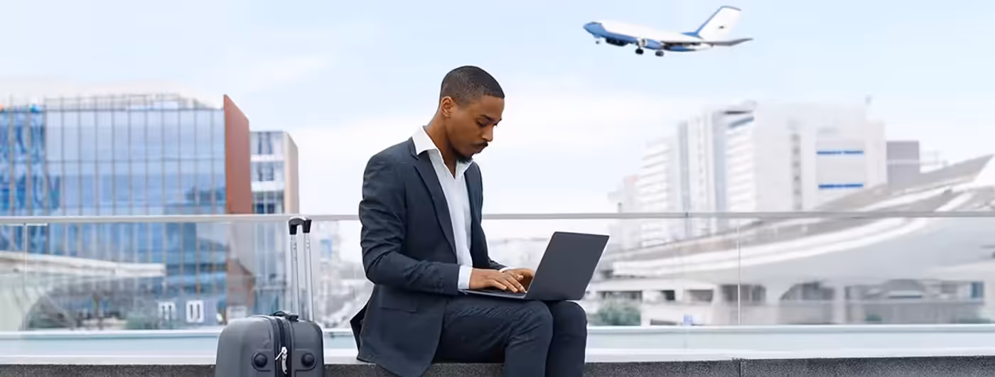 Businessman using a laptop securely with a private hotspot at an airport