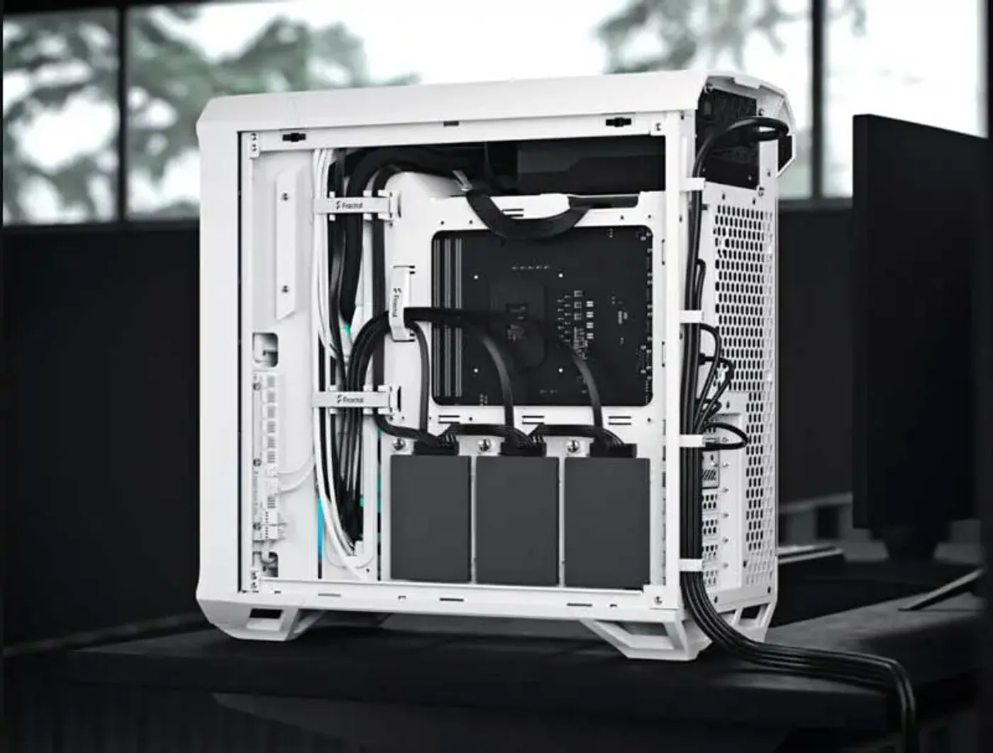 Drive tray, SSD brackets and cable routing clips inside the Torrent Compact