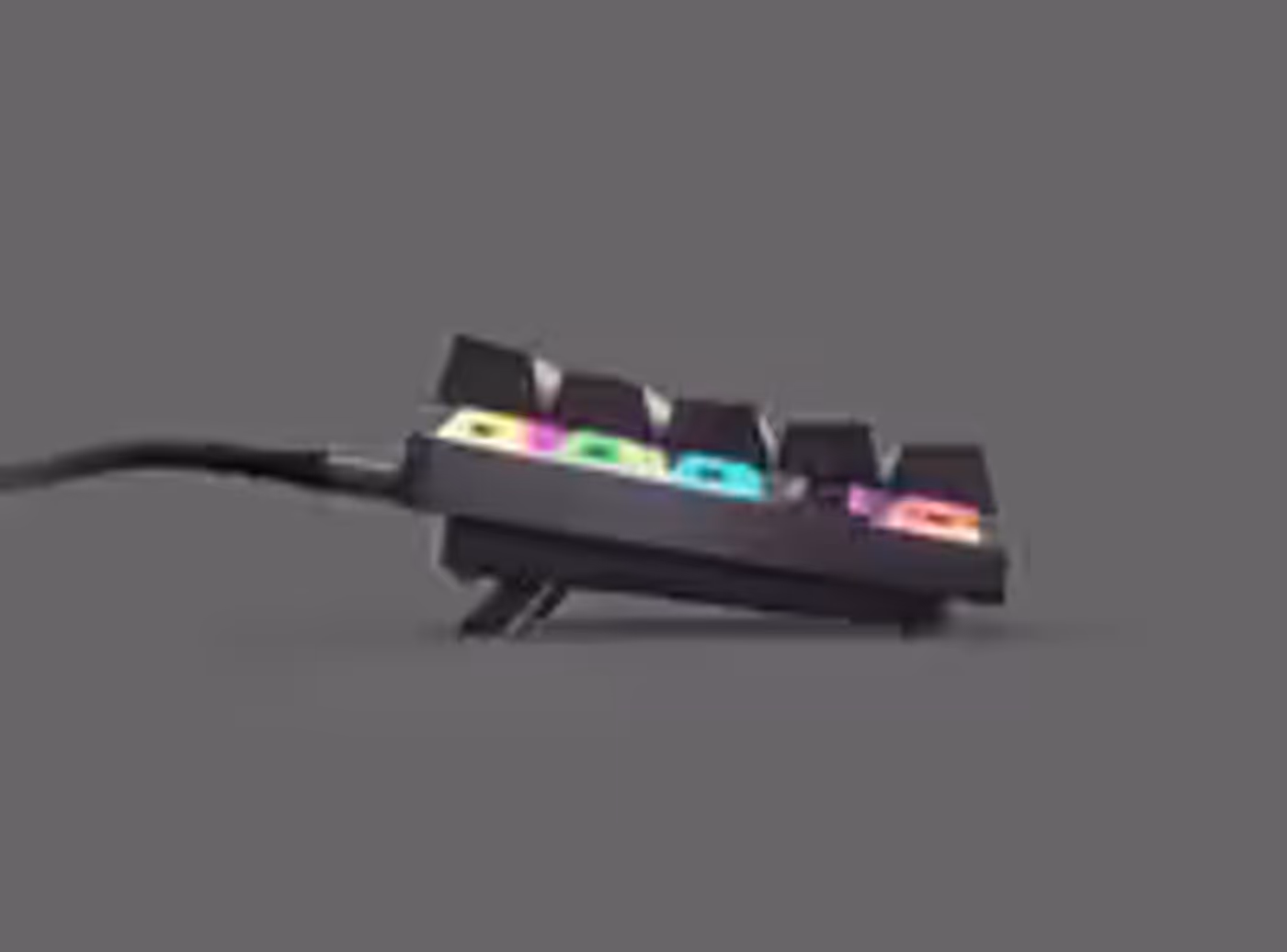 Height-adjustable tilt legs on the underside of the Apex 9 TKL